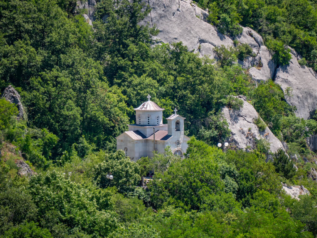 A church surrounded by greenery near Ostrog Monastery.