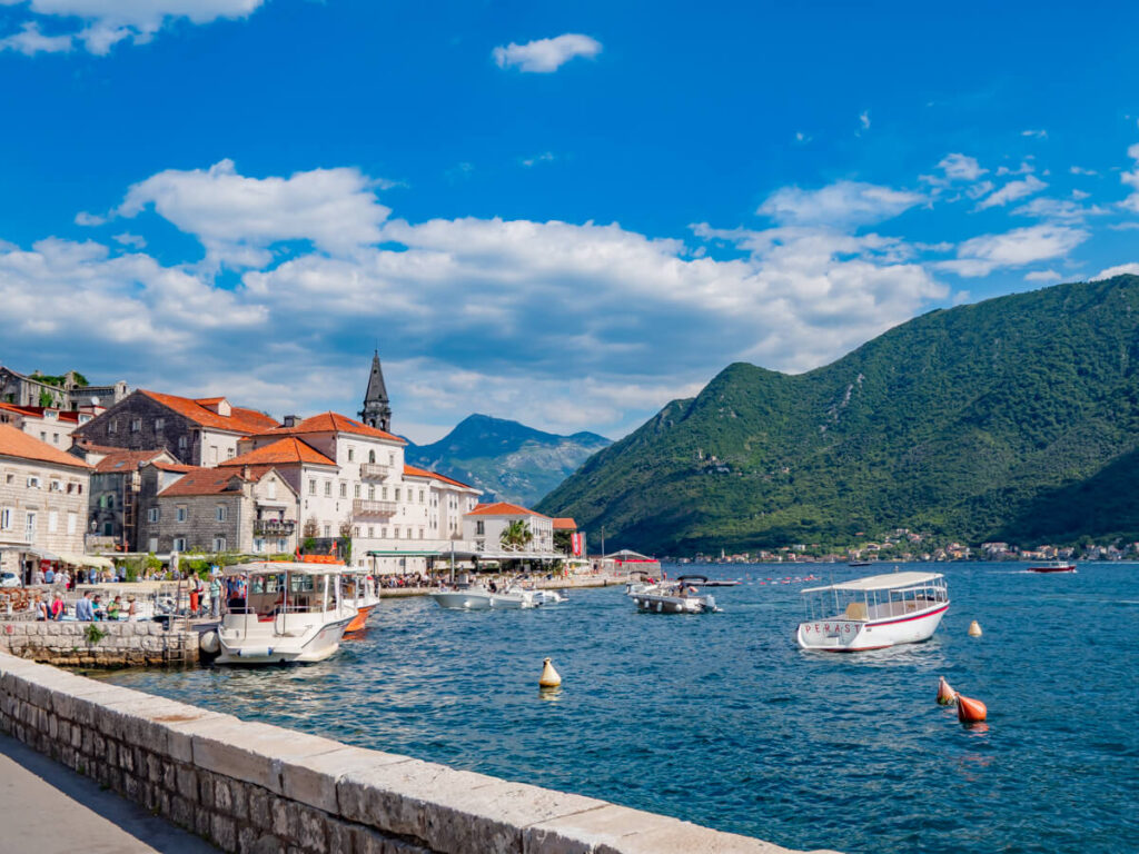 The restaurants and church spires of Perast's waterfront.