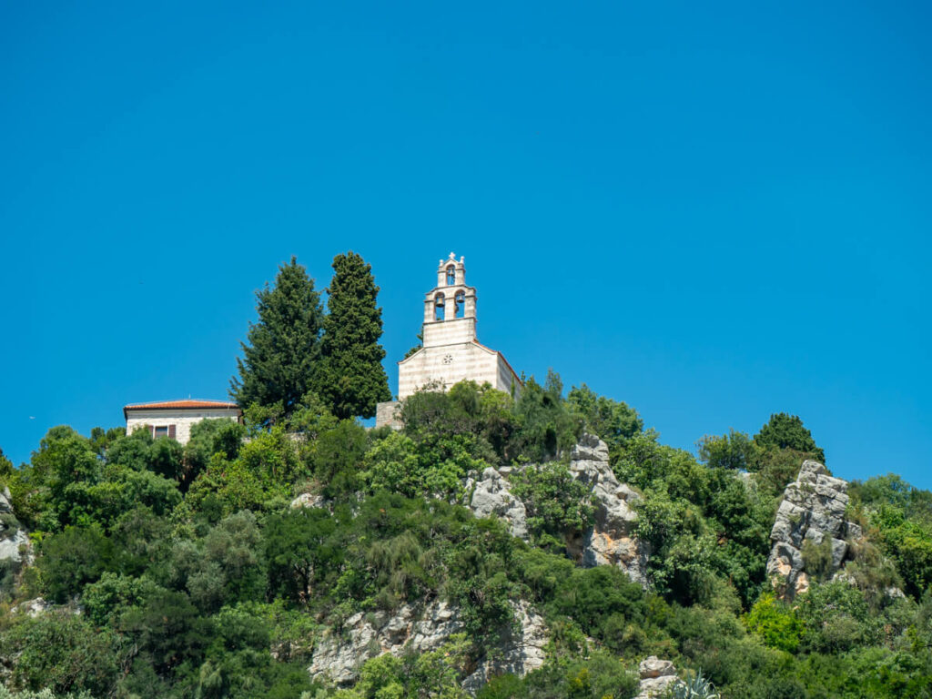 Gradište Monastery surrounded by greenery standing tall on a hill above Petrovac.