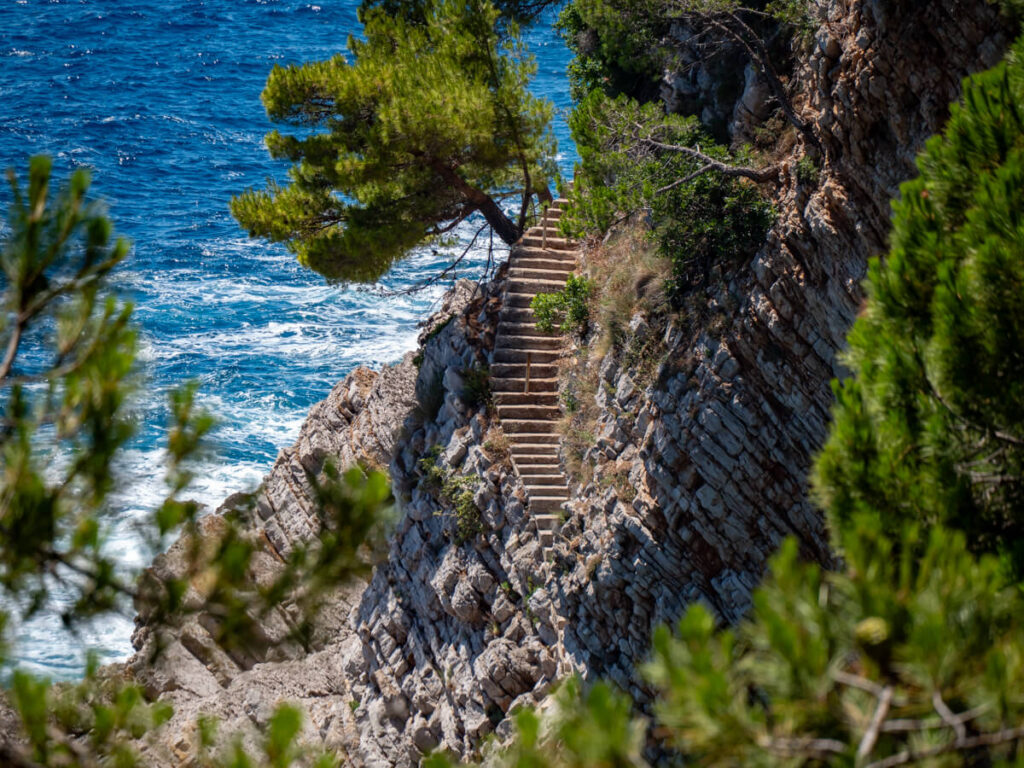 A stone staircase cut into the side of a cliff on the headland near Petrovac.