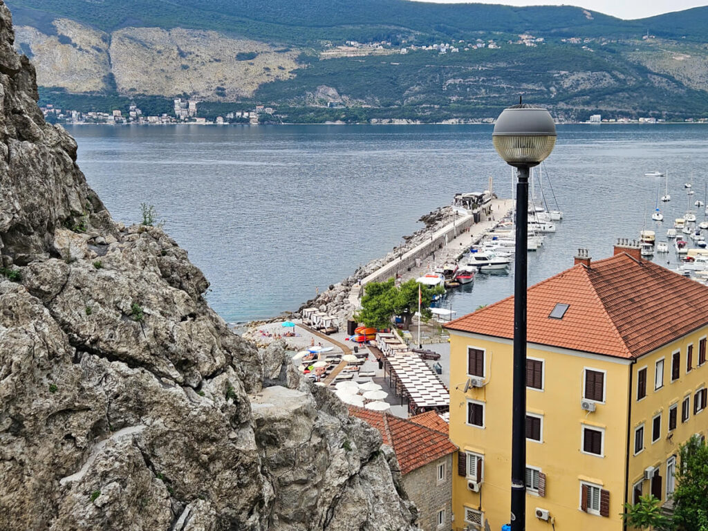 Herceg Novi Pier as viewed from the promenade. The stone walkway juts out into the Bay of Kotor.