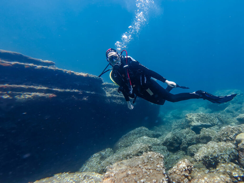 Lucy SCUBA diving by a coral wall in Budva, Montenegro.
