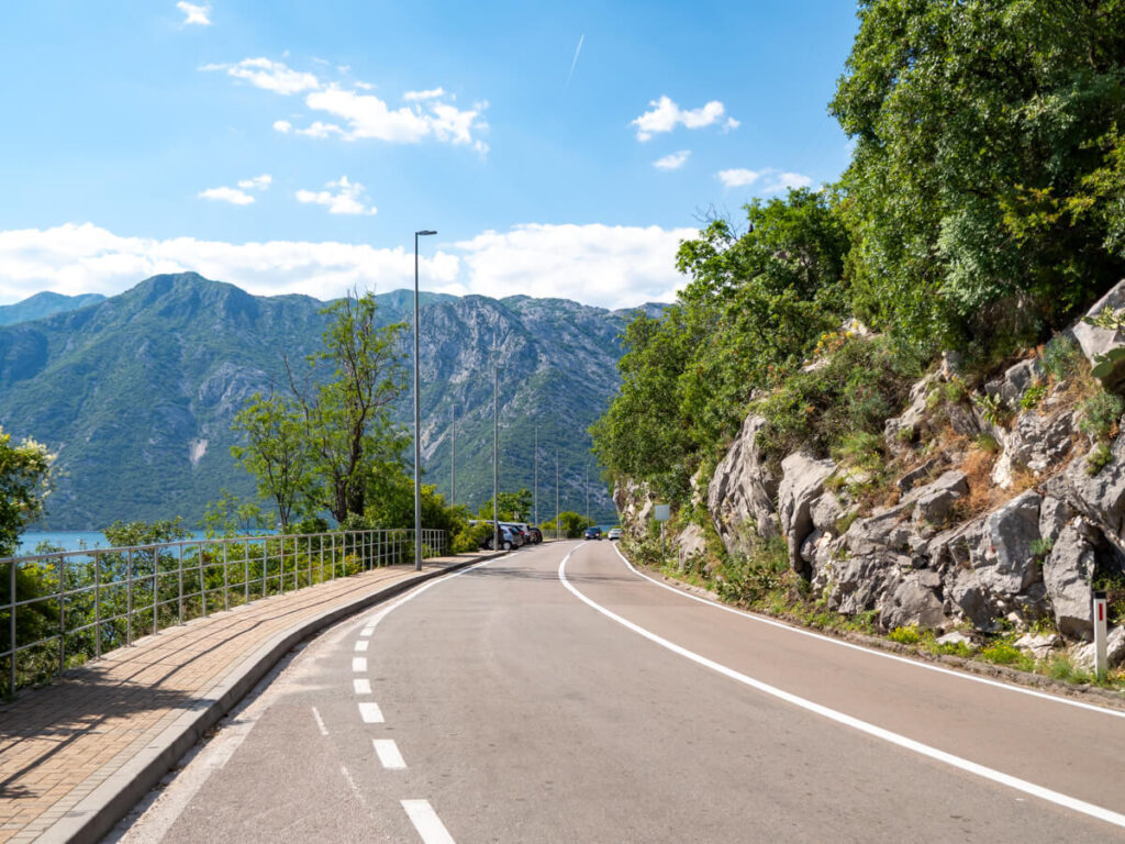 A paved road winding around the Bay of Kotor.