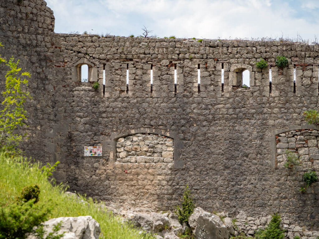 A wall at the back of the San Giovanni Fortress in Kotor with a bricked up window.