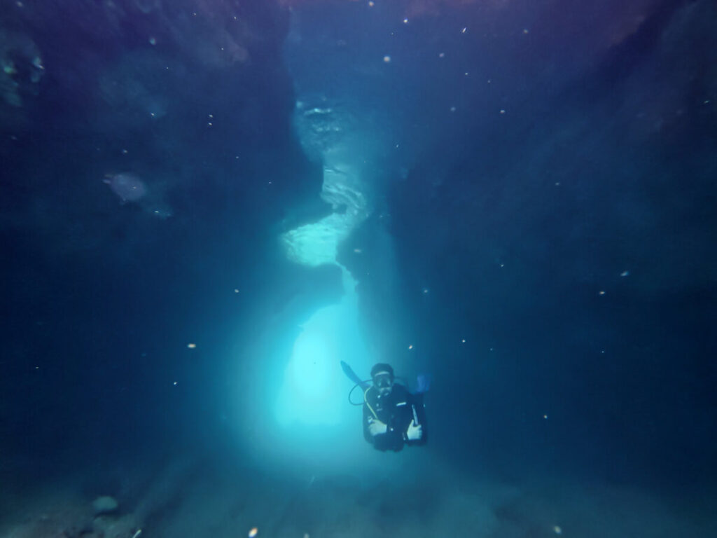 Dan SCUBA diving through a tunnel near Budva, Montenegro.