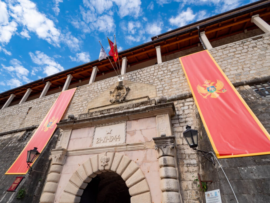 The Sea Gate in Kotor Old Town decorated with Montenegrin flags, the most famous entrance through the city walls.