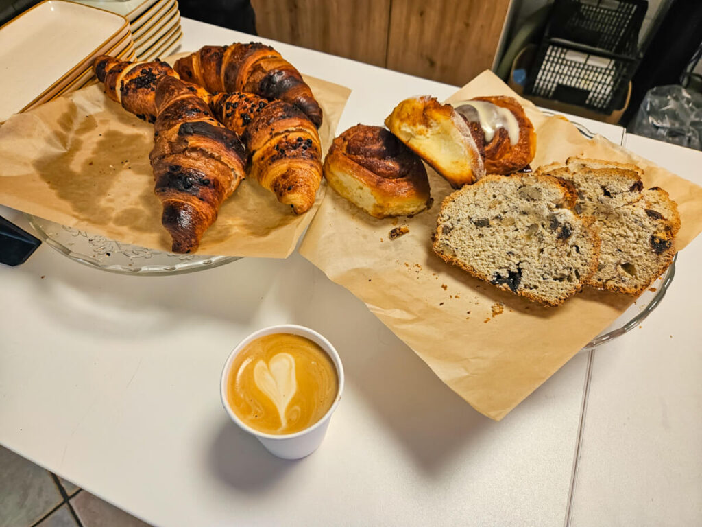 A coffee and pastries on a counter in Small Talks Coffee Shop in Kotor.