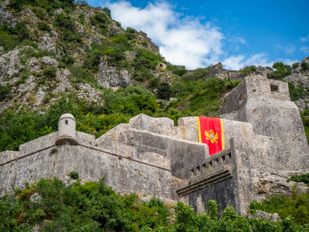 The dramatic San Giovanni Fortress perched on a lush hillside above Kotor.