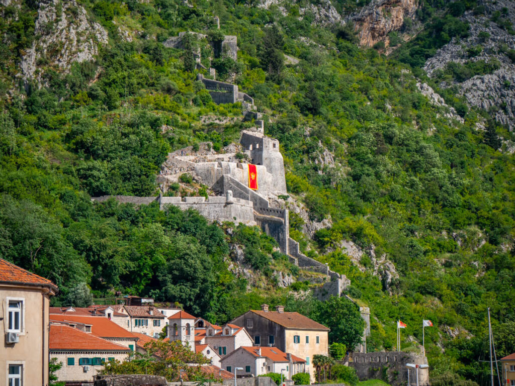 The impressive stone wall of St John's Fortress in Kotor climbing up the mountain and out of sight.