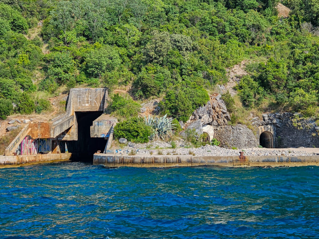 The entrance to a submarine tunnel carved into the Luštica Peninsula, viewed on a Blue Cave boat tour.