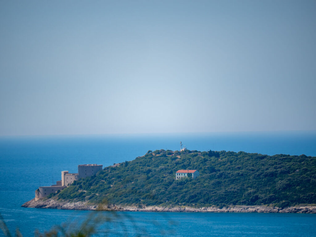 A fortress on the edge of a peninsula in the Bay of Kotor, viewed from the Luštica Peninsula.