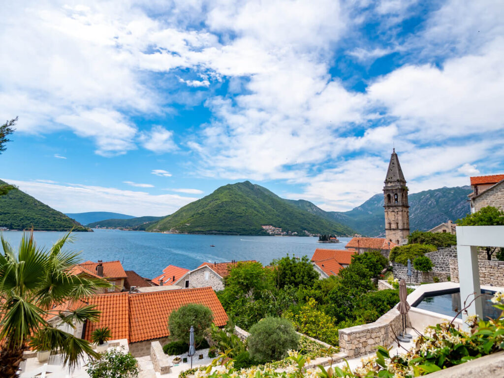 A church tower and terracotta rooves of Perast overlooking the Bay of Kotor.