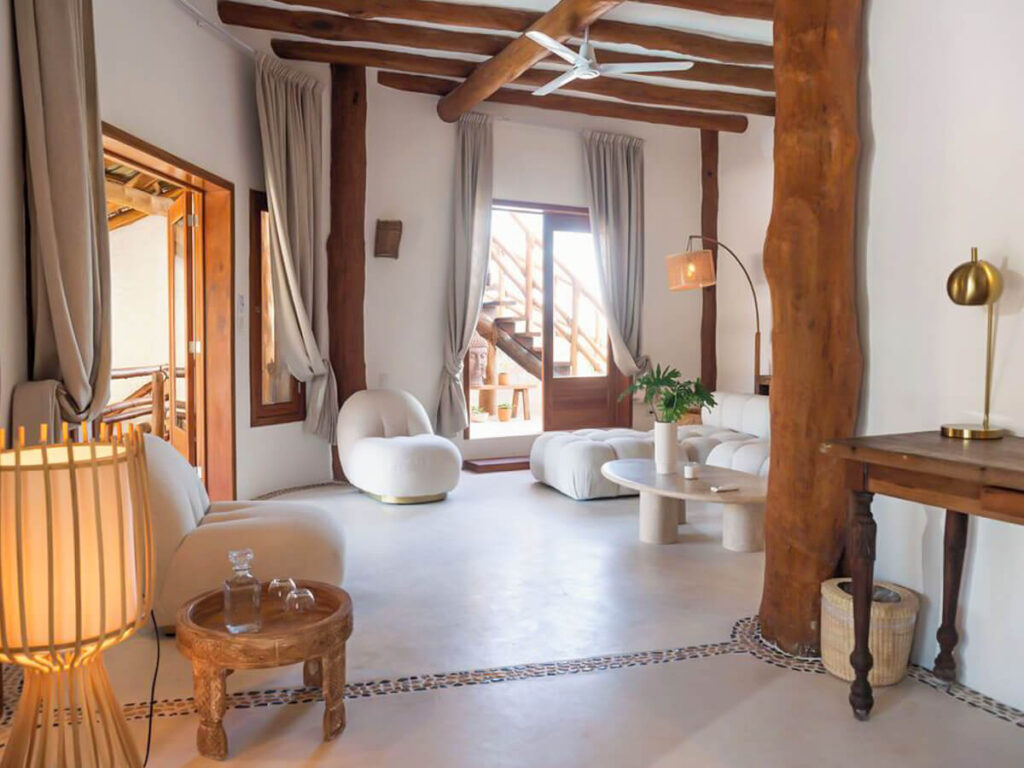 The bright white interior of a lounge area in Casa Las Tortugas, one of the best hotels on Isla Holbox.